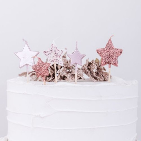 Velas de cumpleaños con estrella de oro rosa.